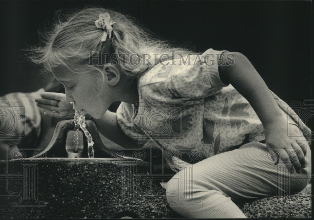 1987, Melissa Harrington getting a drink of water at Summerfest - Historic Images