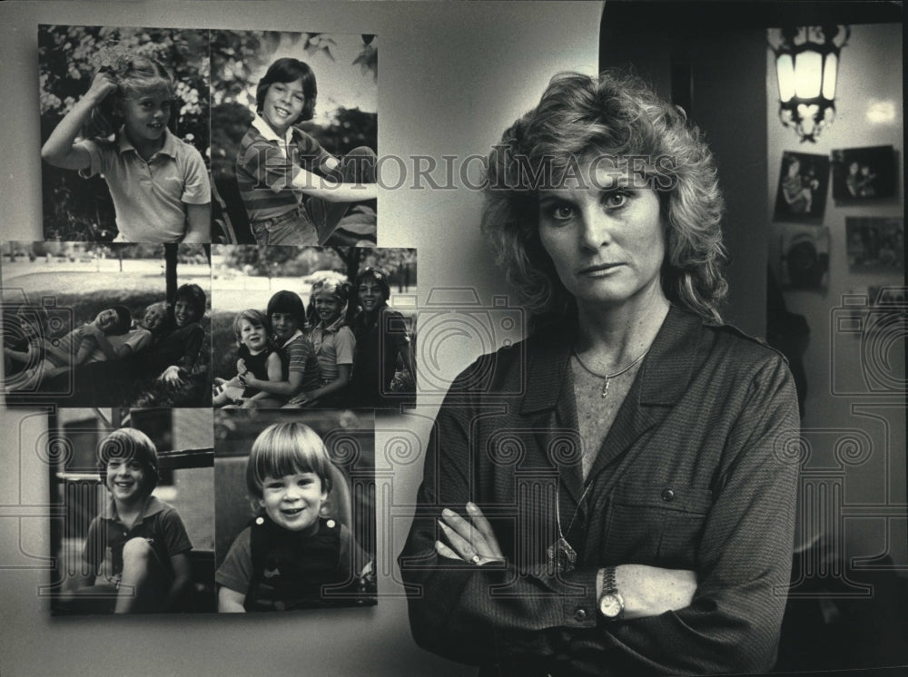 1988 Bonnie Sumner standing by pictures of her children in Shorewood - Historic Images
