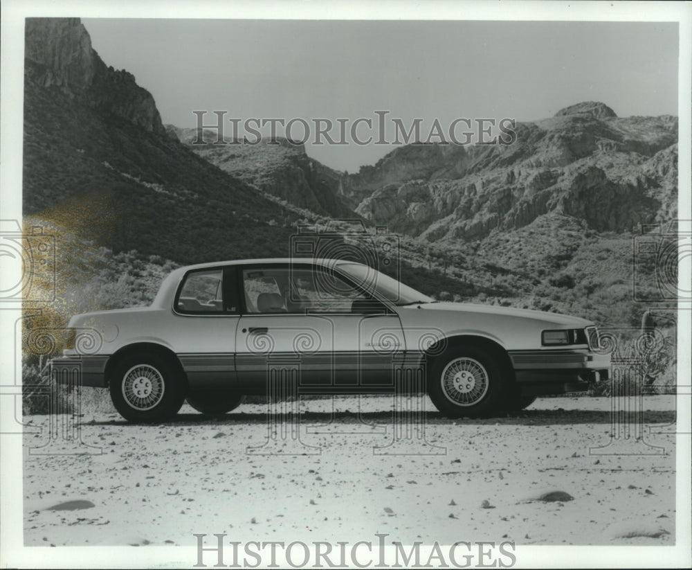 1984 1985 Pontiac Grand Am, parked in front of mountains - Historic Images