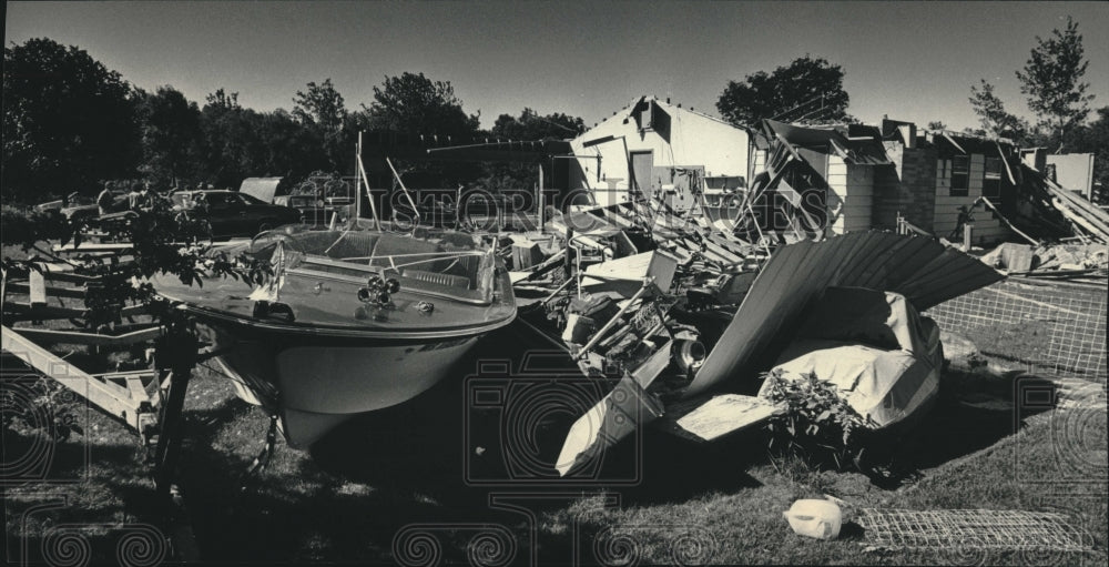 1985, Debris scattered across lawn after tornado in Menomonee Falls - Historic Images