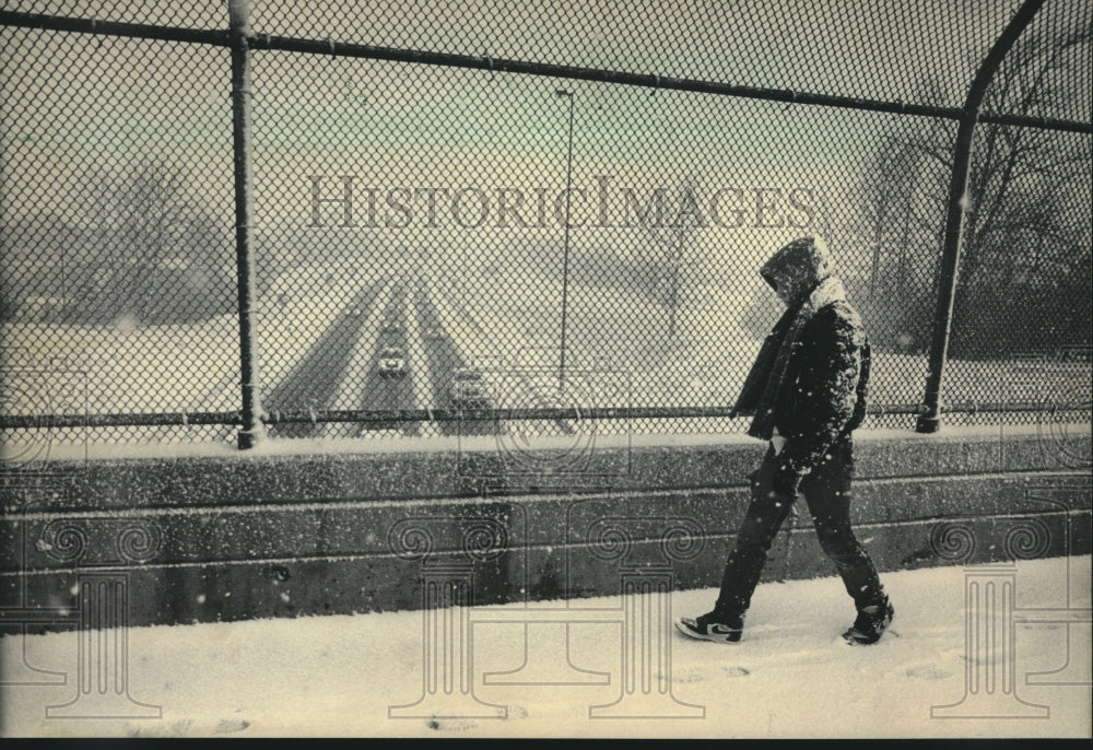 1986 Eddie Wojciechowski walking to school in the snow, Wisconsin - Historic Images