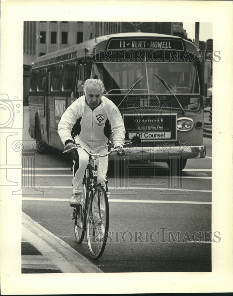 1980 A slimmer Christ T. Seraphim on his bicycle - Historic Images