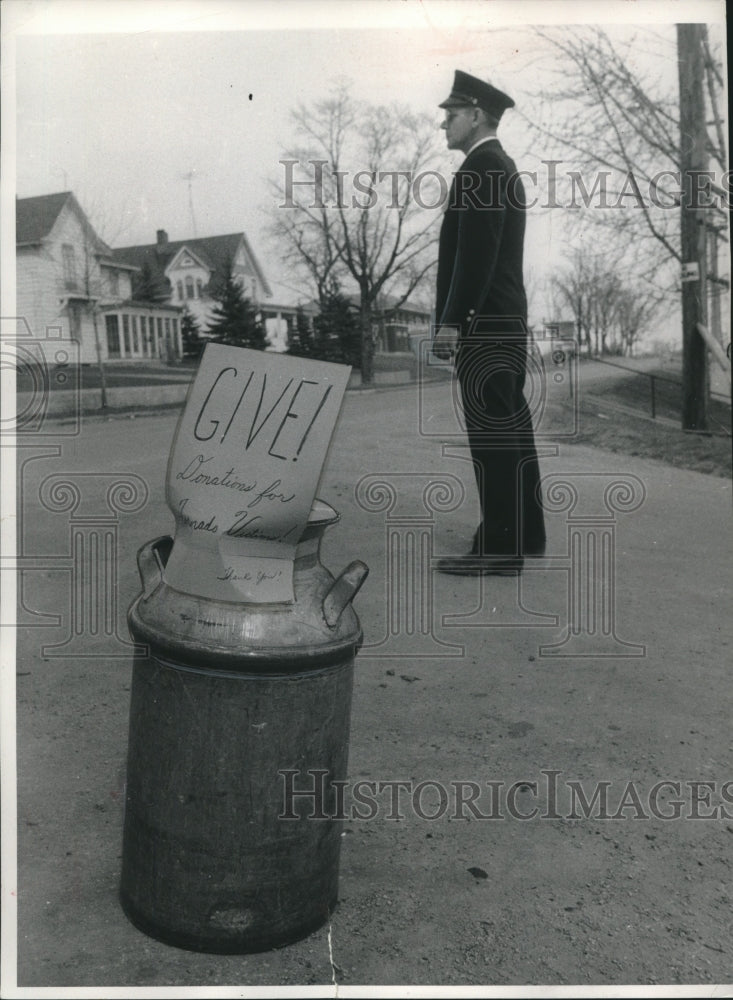 1956, Oshkosh policeman Roy Roethlisberger taking donations - Historic Images