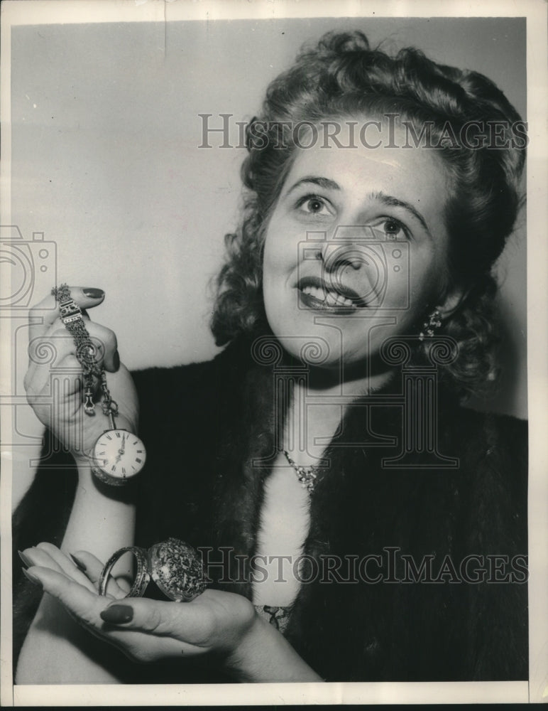 1949, Genny Mattli holding most valuable antique watch, New York. - Historic Images