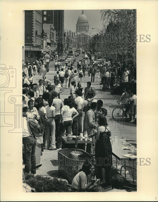 1981, UW Madison students welcome spring to State Street with beer - Historic Images