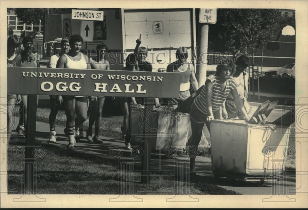 1983, UW-Madison students cart their things into their dormitory - Historic Images