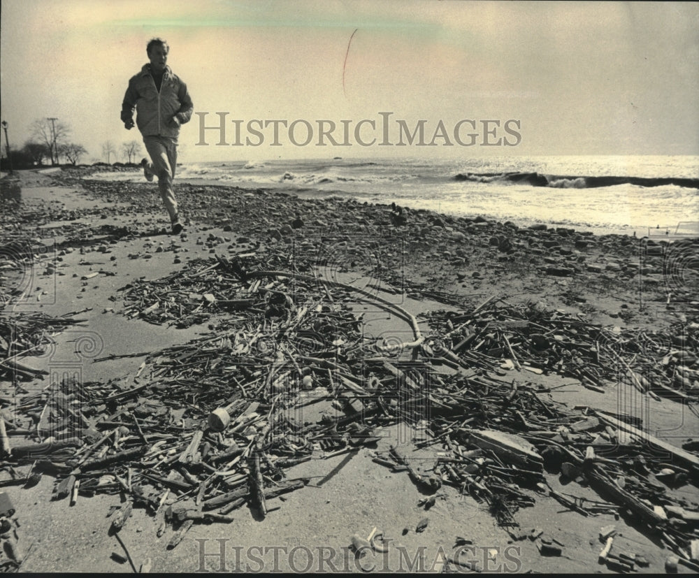 1983 Press Photo A jogger runs on sidewalk among shipwreck debris - mjc25524 - Historic Images