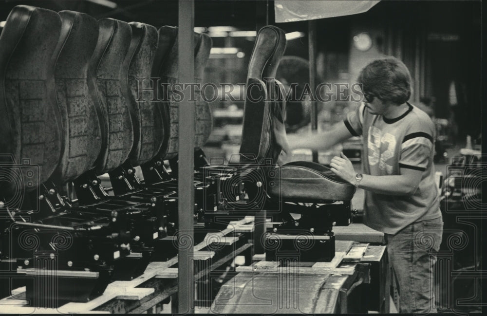 1984 Seats Inc. worker, Bob Schroeder, prepares line of truck seats - Historic Images
