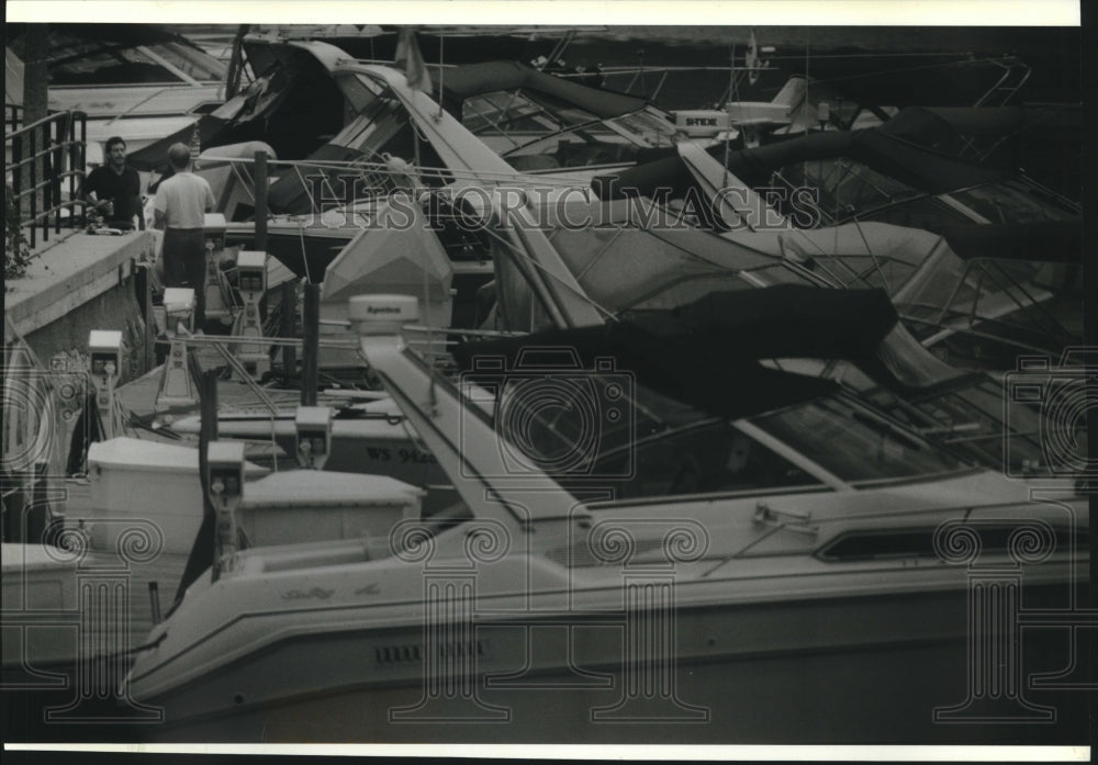 1994 Boaters docked on Milwaukee River chat near their craft - Historic Images