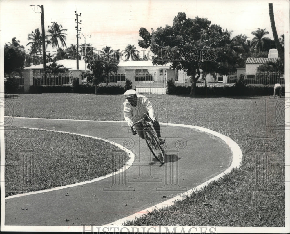 1962 Press Photo General Marcos Perez Jimenez riding bike on his track, Miami. - Historic Images