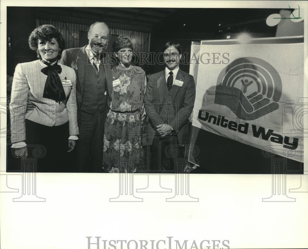 1983, Executives lent to United Way campaign stand by sign, Waukesha. - Historic Images