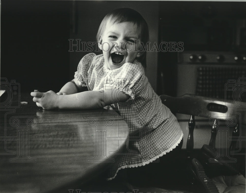 1982 Jessica at table, has Idiopathic precocious puberty, Green Bay. - Historic Images