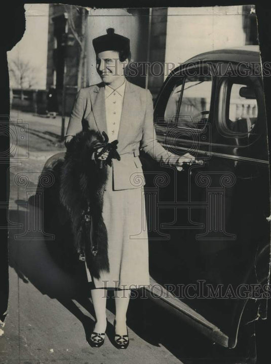 1938, Mrs. Edward S. Tallmadge with a mink wrap & hand on her auto - Historic Images