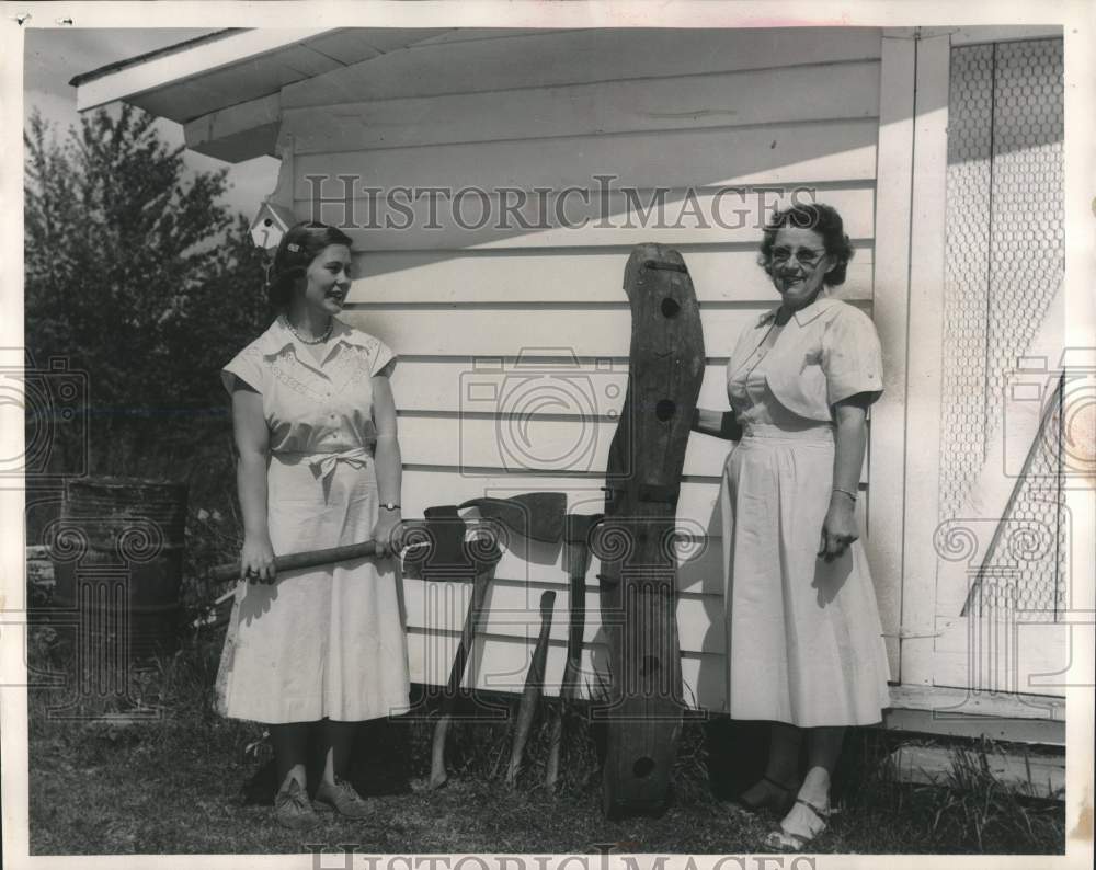 1953, Marcia Roos &amp; Mrs. Herman Lassig with a oxen yoke &amp; axes - Historic Images