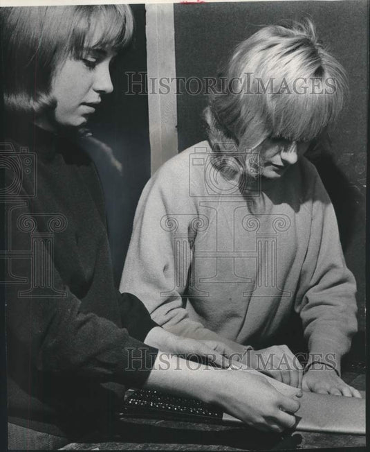 1966, Gwyn Lathrop and Barb De Rocher wrap traction mats for snow. - Historic Images