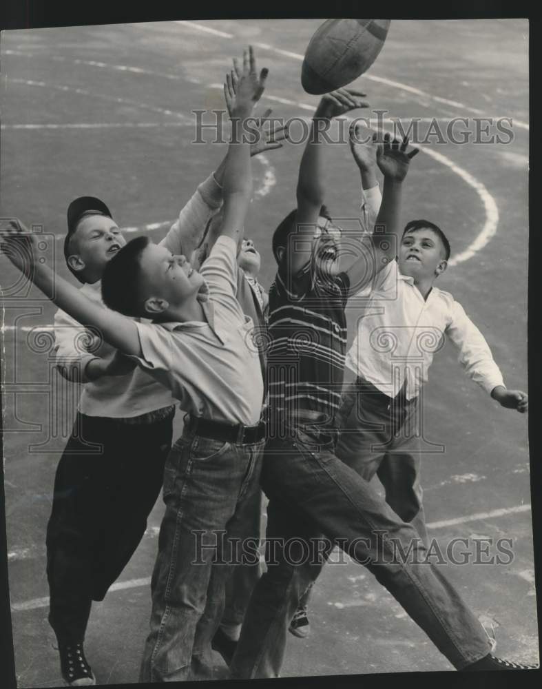 1954, Youngsters try to get football at playground in Milwwaukee - Historic Images
