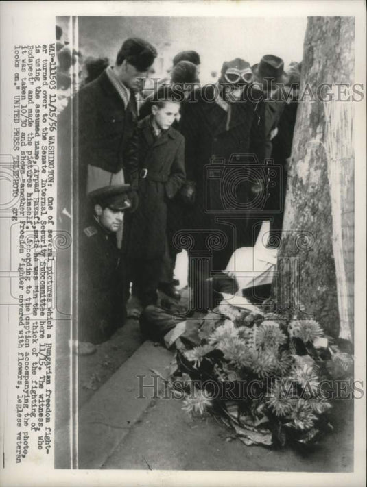 1956, Hungarian freedom fighter covered in flowers, Budapest - Historic Images