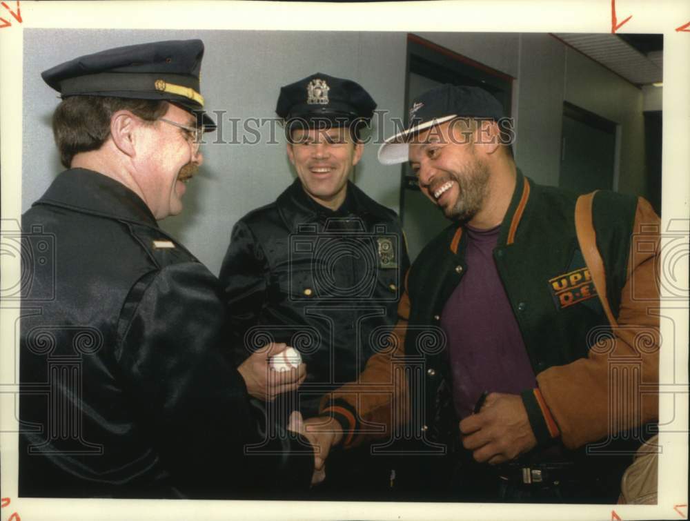 1993 Press Photo Reggie Jackson congratulated by police officers in New York - Historic Images