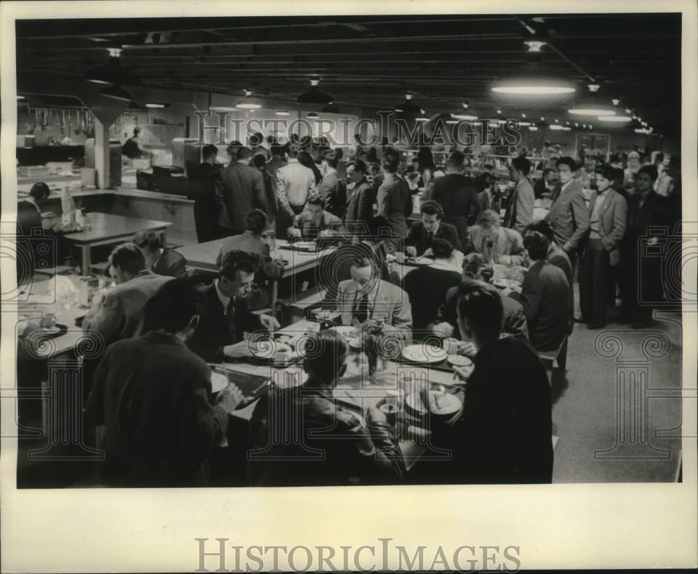 1957, Hungarian refugees enjoying dinner at a community college - Historic Images