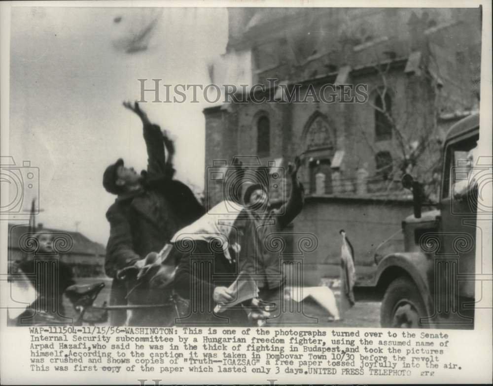 1956, Hungarians tossing newspapers in the air during the revolt - Historic Images