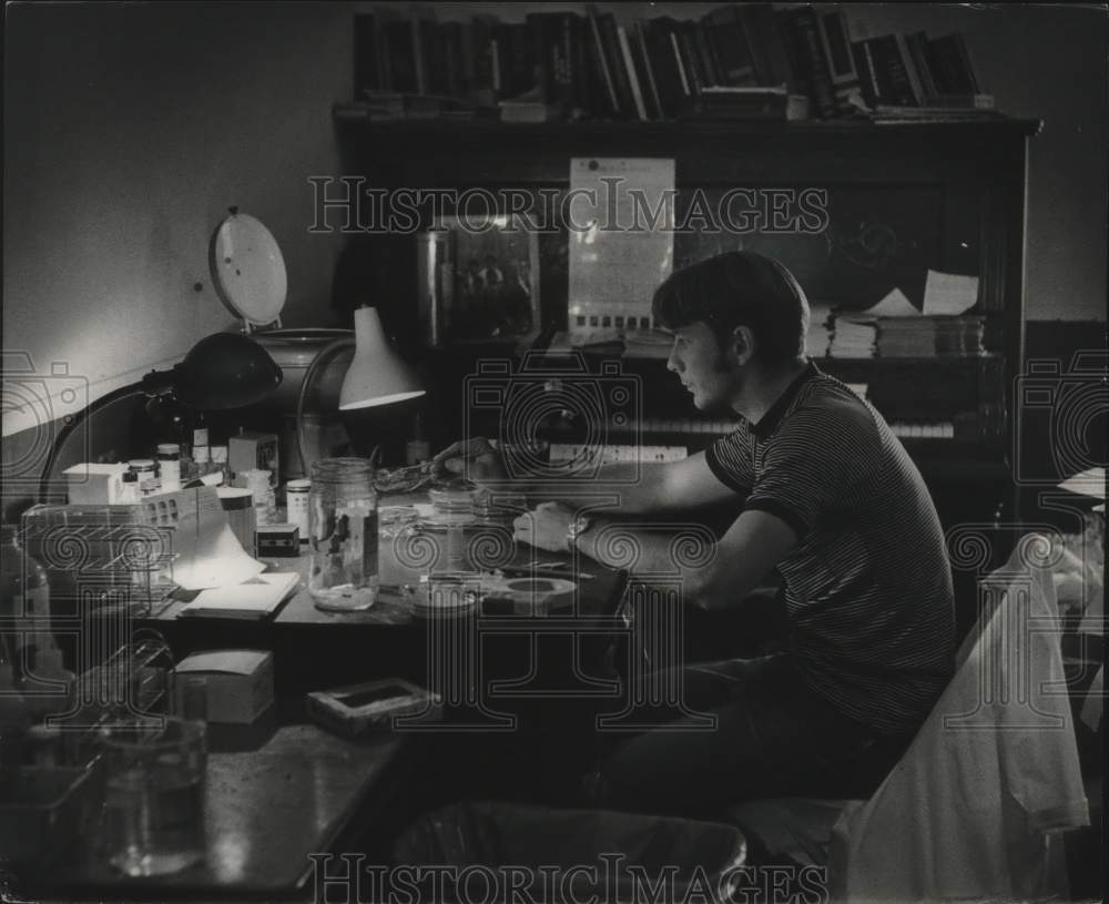 1970, Jack Tenge examines a specimen at University of Wisconsin - Historic Images