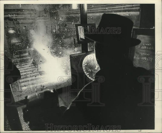 1971, Steel worker guides machinery to shape ingots - mjc28996 - Historic Images