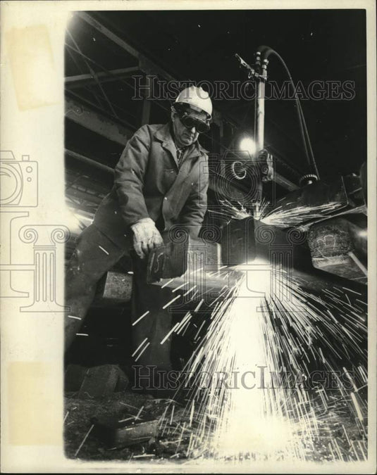 1971, Trimmer's torch sparks as excess metal is trimmed from steel - Historic Images