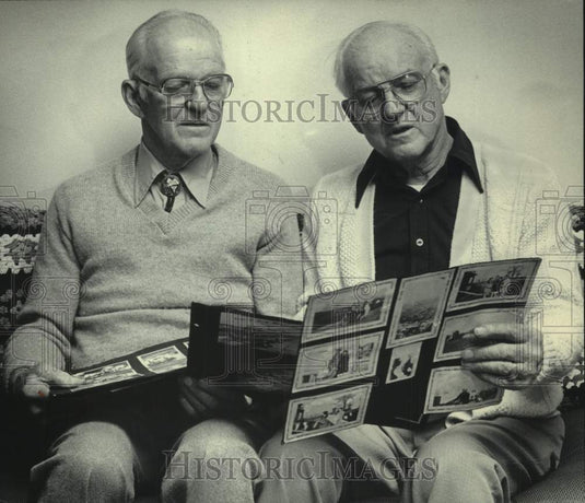 1985 Press Photo Pilots Dale & Dean Crites looking at photos - mjc31280 - Historic Images