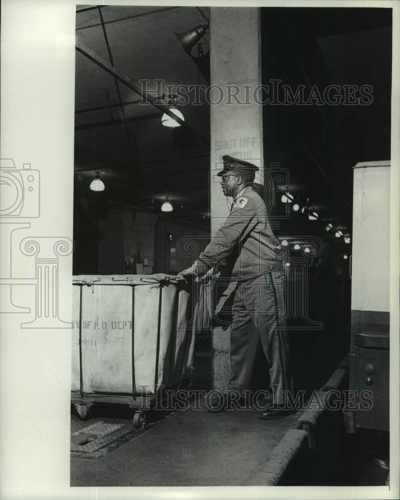 1976 Postal worker with mail sorting cart on loading dock, Milwaukee ...