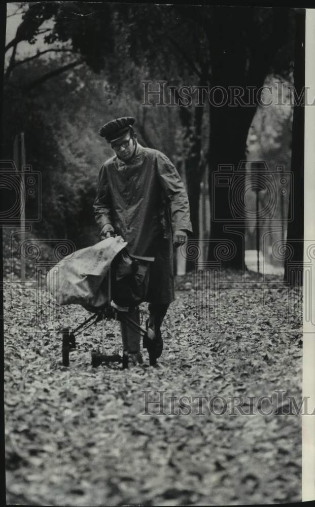 1970, Mailman Gerald Mundschau delivers mail in the rain, Wauwatosa - Historic Images