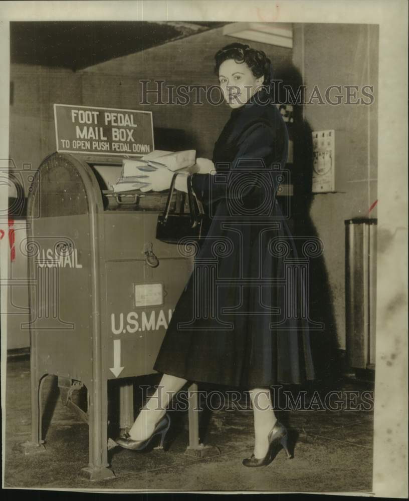 1956, Alberta Moran demonstrates new experimental mailbox feature - Historic Images