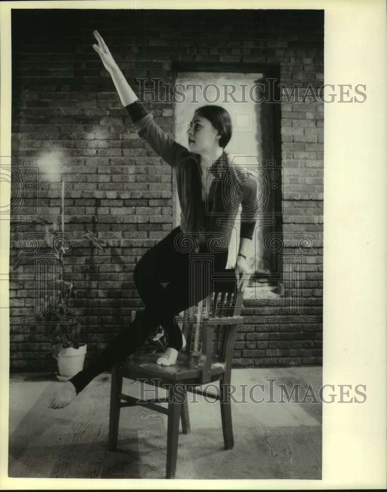 1980 Press Photo Dancer Christine Stevens struck elegantly poses with red chair. - Historic Images