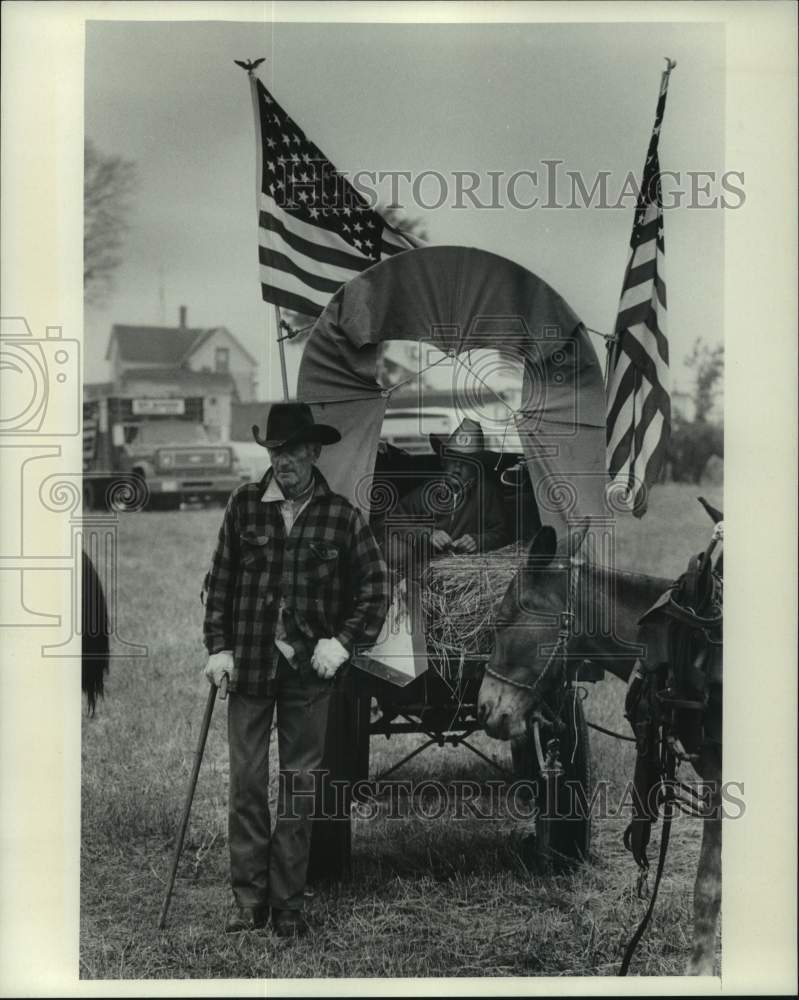 1976 Press Photo Two generations of cowboys teamed up in a donkey pulled wagon. - Historic Images