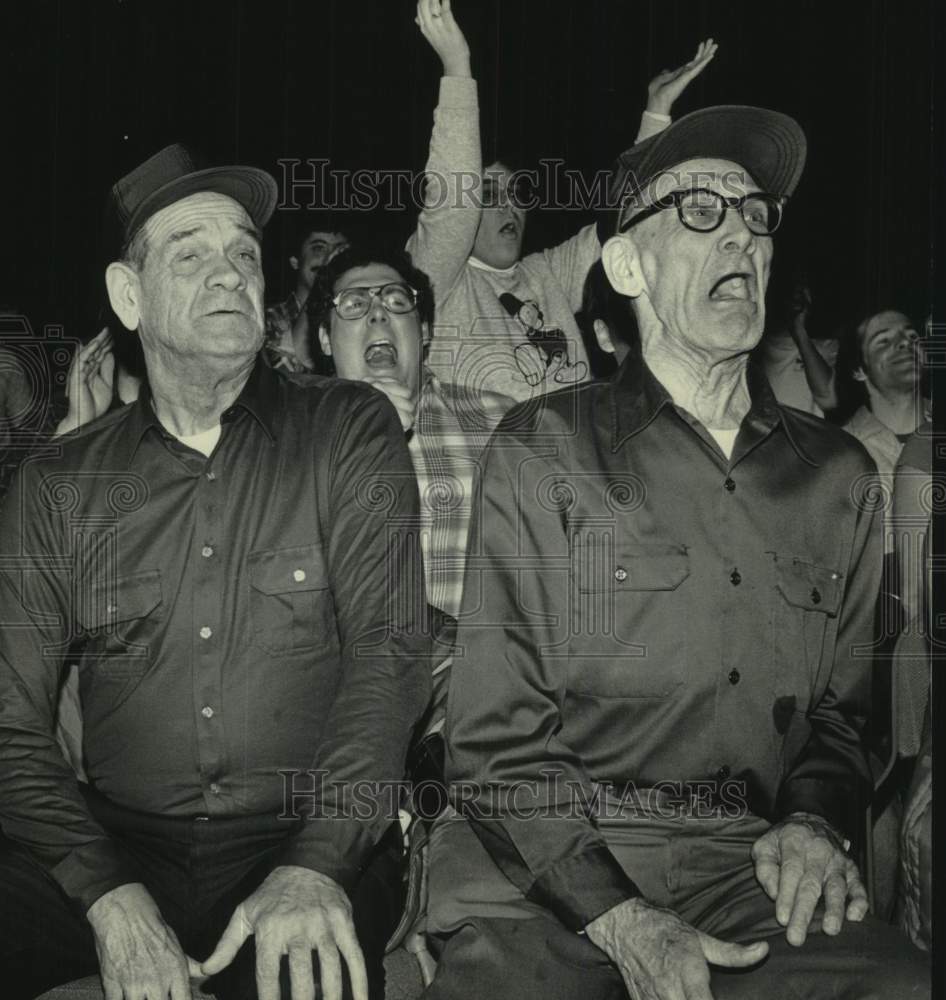 1985 Press Photo Jim and Richard Tyriver watch Wrestling Card, Milwaukee, WI - Historic Images