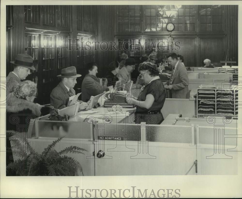 1958 Press Photo Customers at Philatelic Sales Agency looking at stamps - Historic Images