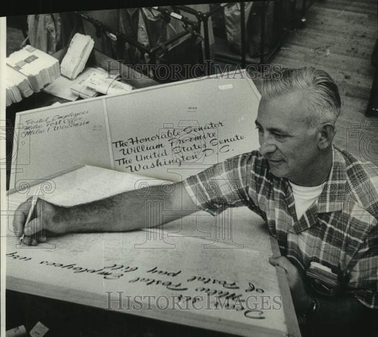 1962, Earl Legan signs postcard going to the President Milwaukee - Historic Images