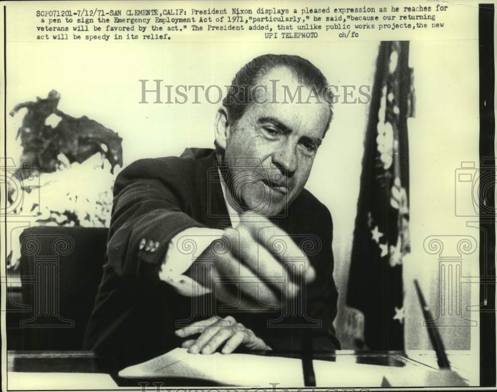 1971, Pres. Nixon reaches for a pen to sign Emergency Employment Act - Historic Images