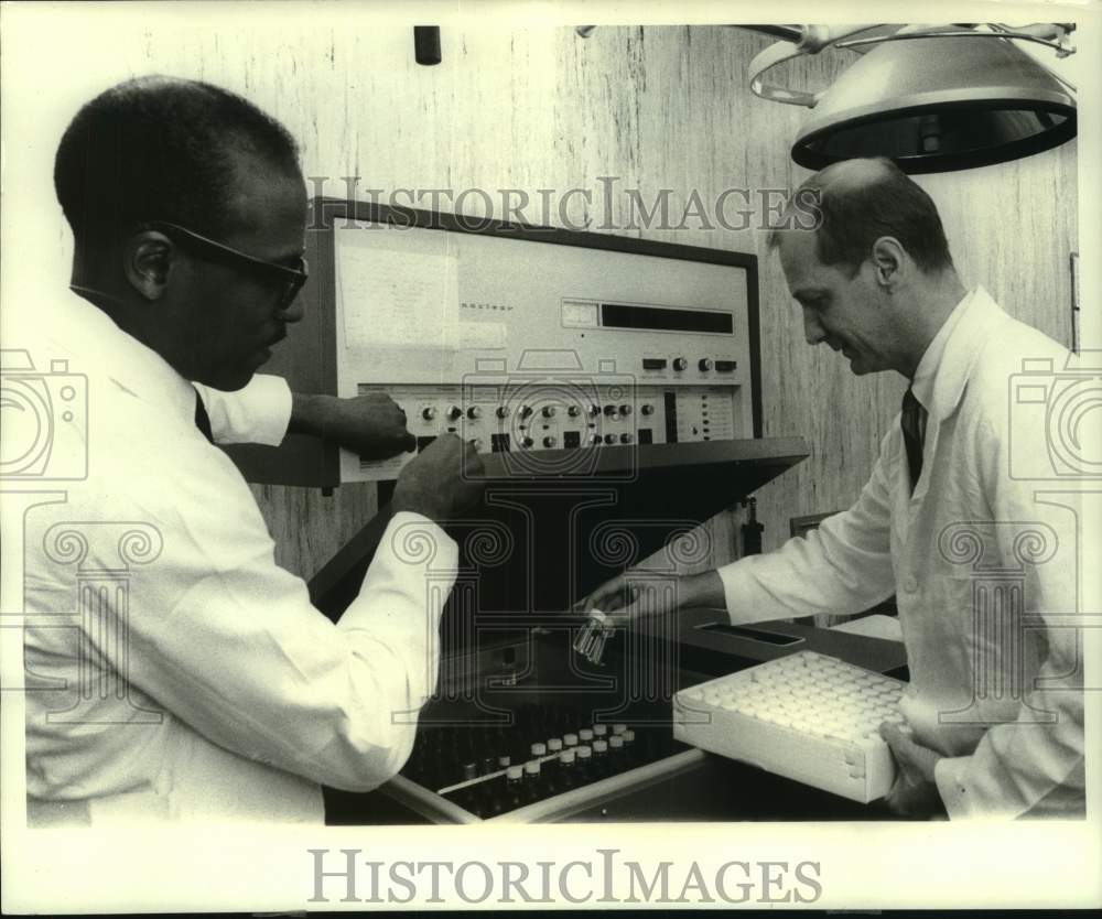 1970, Pharmacologists Earl Butler and James G Overpack study biopsies - Historic Images