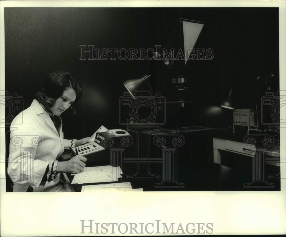 1970, Microbiologist Arlene Porteous uses a computer for results. - Historic Images