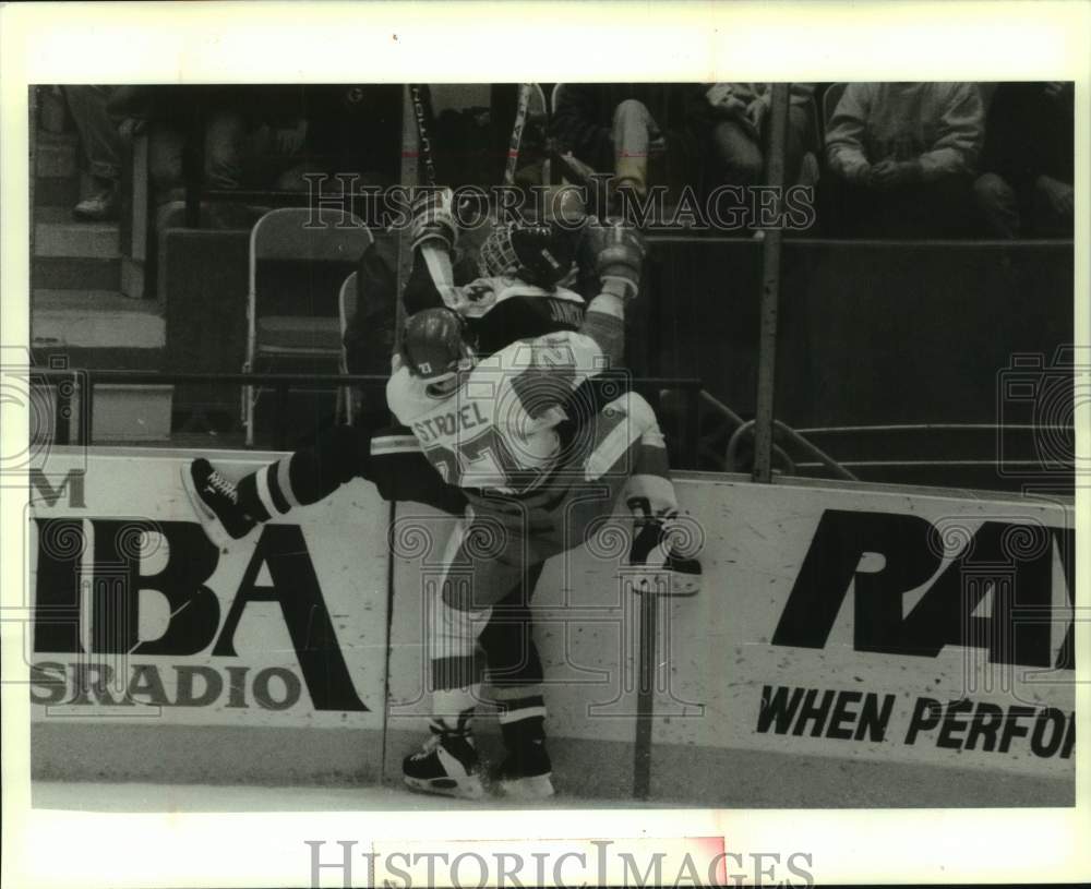 1993 Press Photo Univ of Wisconsin hockey player crashes into N. Michigan player - Historic Images