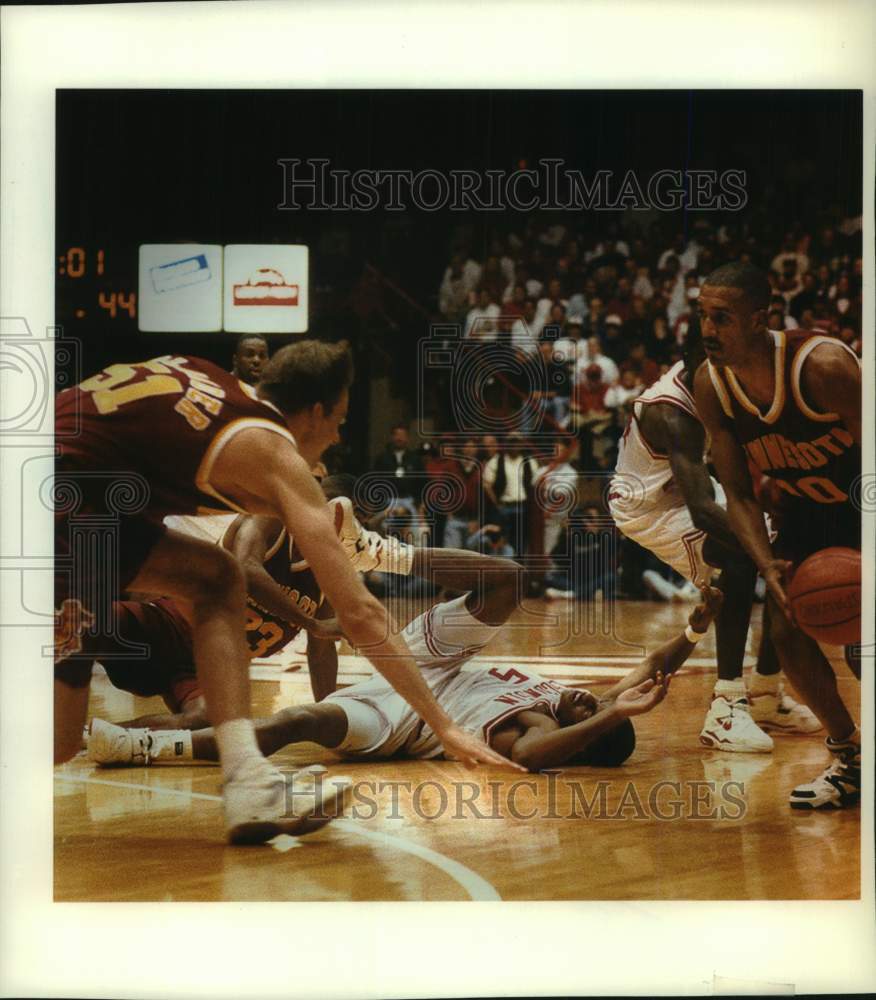 1994 Press Photo Jalil Roberts knocked down in game with Minnesota at Madison - Historic Images