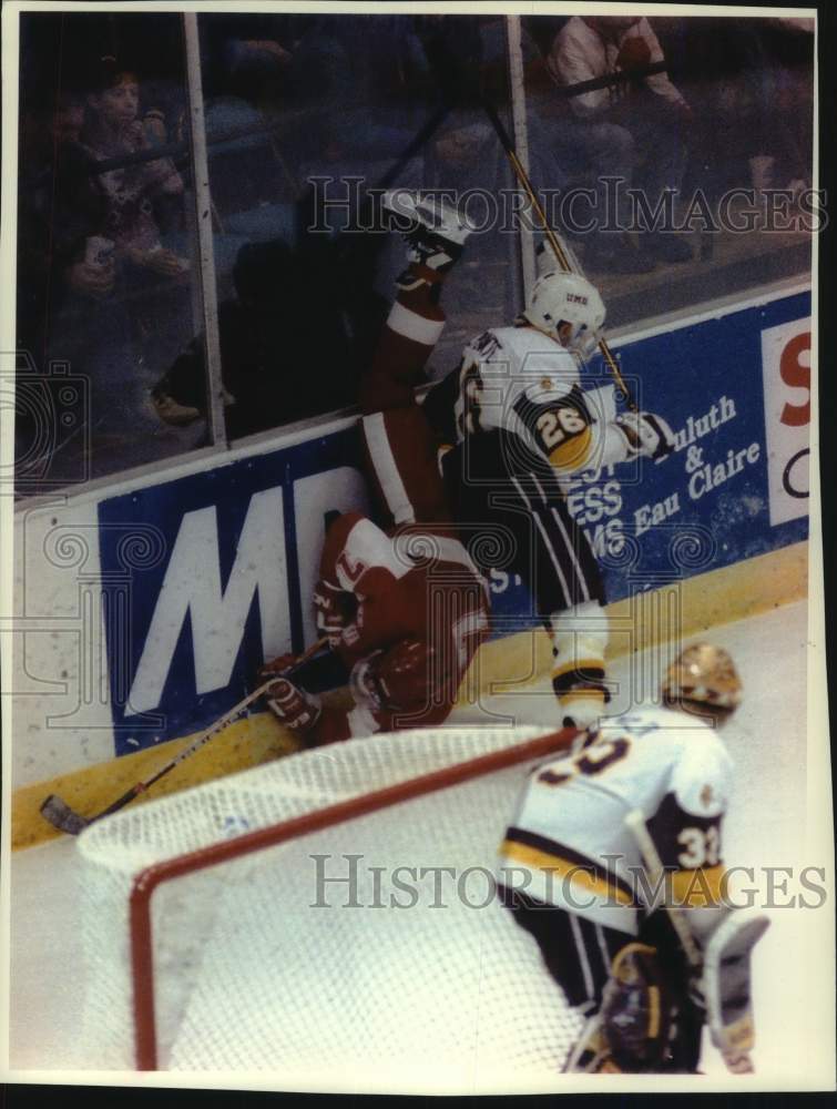 1992 Press Photo University of Wisconsin Hockey player gets knocked down, Duluth - Historic Images