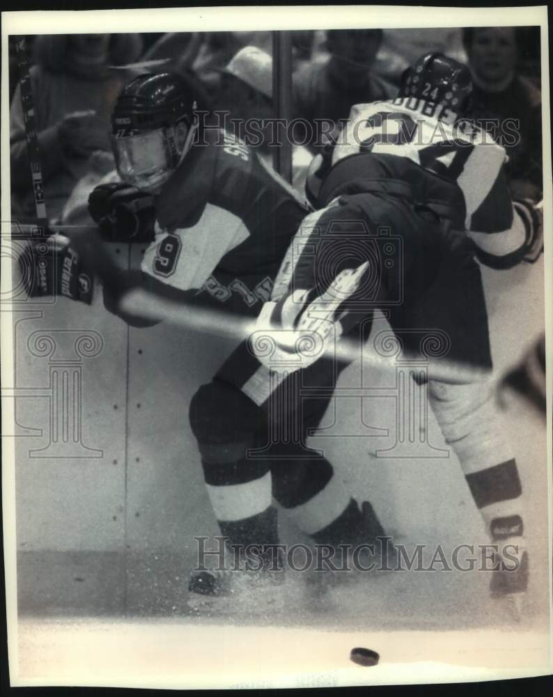 1994 Hockey Badger Andrew Shier tries to get loose from a leg check. - Historic Images
