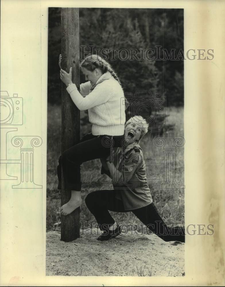 1988, Danish Girl Scouts playfully try to climb a pole. - mjc34617 - Historic Images
