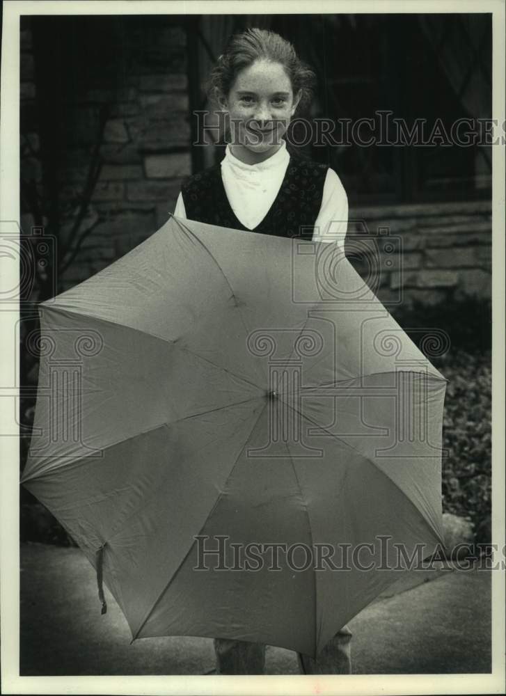 1990, Joan Kowalski holds Umbrella she held when struck by Lightning - Historic Images