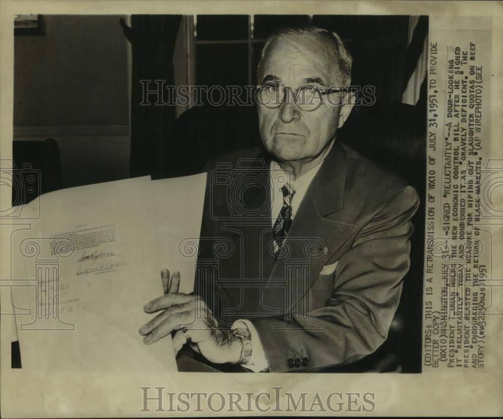 1951 President Truman holding a bill he signed, Washington - Historic Images