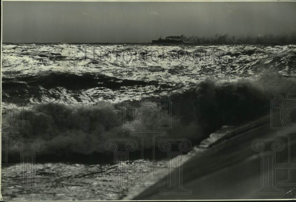 1939, Waves tossed over breakwater as 28 mile wind lashes city - Historic Images