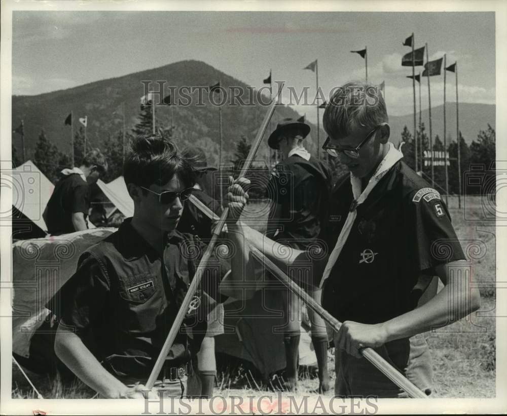 1967 Boy Scouts put together tent poles at Jamboree - Historic Images