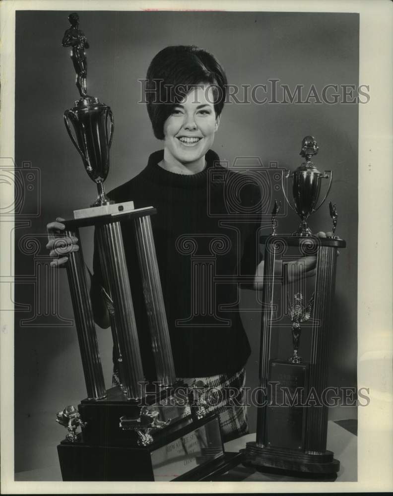 1967, Davida Wichern Displays Trophies for Snowmobile Races - Historic Images