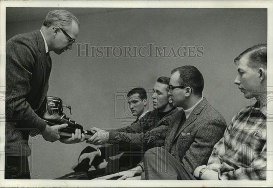 1964 Ski instructors learn ski boot mechanics at class in Milwaukee - Historic Images
